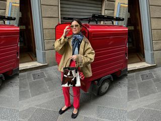 Fashion influencer Vicky Montanari wearing Maison Margiela Tabi ballerina flats, red jeans, a cropped trenchcoat, blue scarf, sunglasses, and carrying a Tory Burch cow print bag.