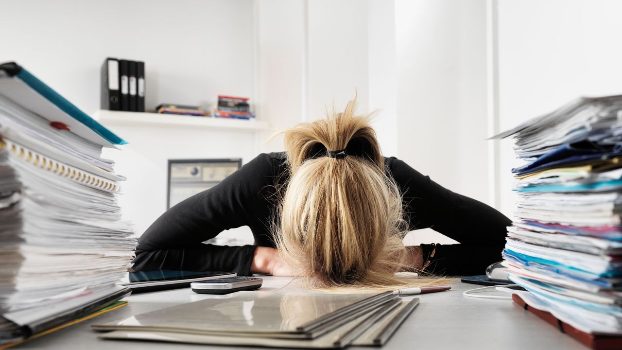 Woman with head on desk