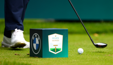 A close up of a BMW PGA Championship tee marker and a golf ball