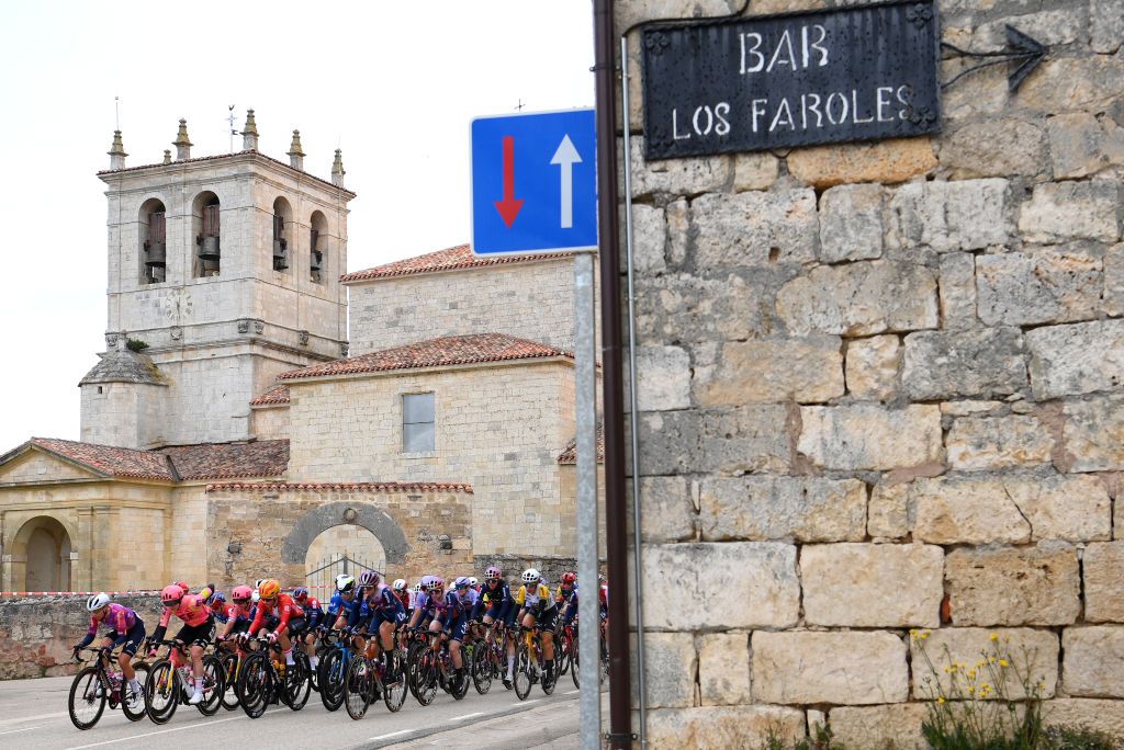 BURGOS SPAIN MAY 16 A general view of the peloton passing through a Huermeces village during the 9th Vuelta a Burgos Feminas 2024 Stage 1 a 123km stage from Villagonzalo Pedernales to Burgos UCIWWT on May 16 2024 in Burgos Spain Photo by Alex BroadwayGetty Images