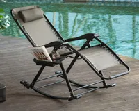 A grey zero-gravity folding rocking chair by the side of a turquoise swimming pool