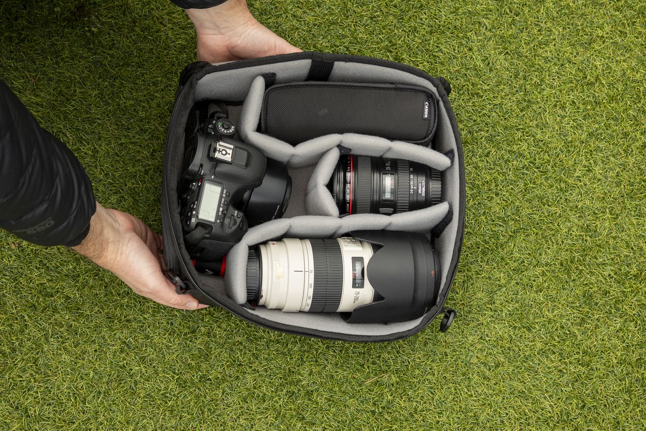 inside a camera backpack with internal dividers, being removed