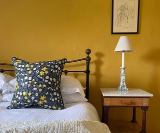 mustard yellow bedroom with side lamp