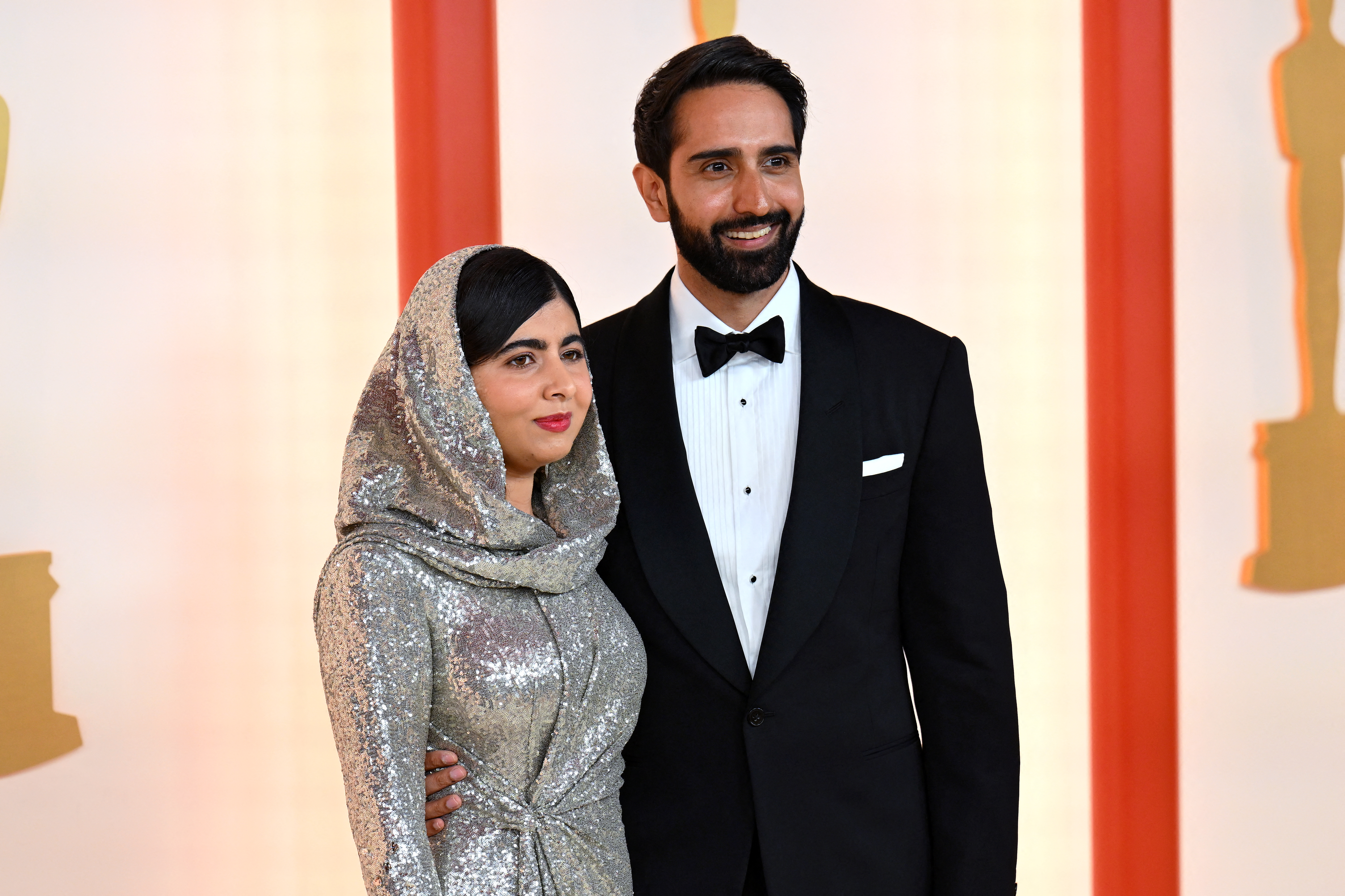 Malala Yousafzai and her husband, Asser Malik, arrive at the Oscars red carpet&amp;mdash;she in a silver sequined gown and matching headscarf, he in a classic tuxedo.