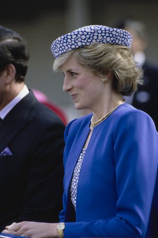 Princess Diana wears a blue dress with butterfly earrings for a visit to Canada in 1986