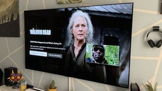 Scene from Netflix's The Walking Dead shown on an LG OLED TV hanging on wall in living room