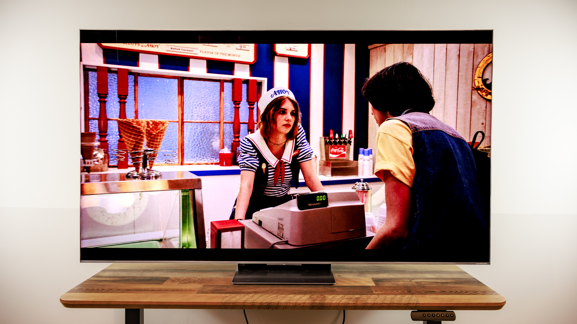 A TCL QM8L TV on a desk