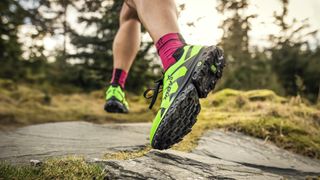 Person's feet wearing trail running shoes with socks