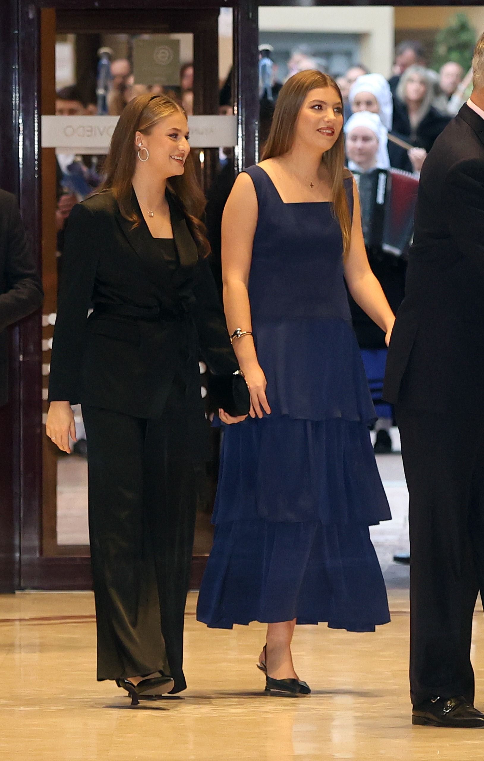 Princess Leonor in a black suit and Infanta Sofia wearing a blue dress
