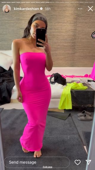 Kim Kardashian in a strapless bright pink dress.