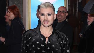 Danny Beard attends The 25th Annual WhatsOnStage Awards at the London Palladium in a black shirt with silver stars on it