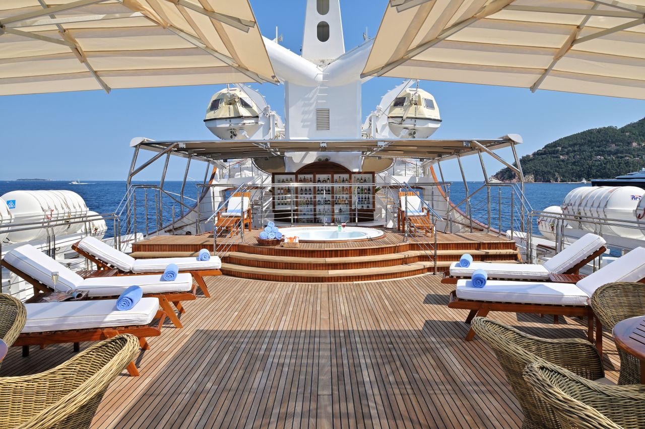 A view of the rear deck of the boat, with sun loungers and the jacuzzi