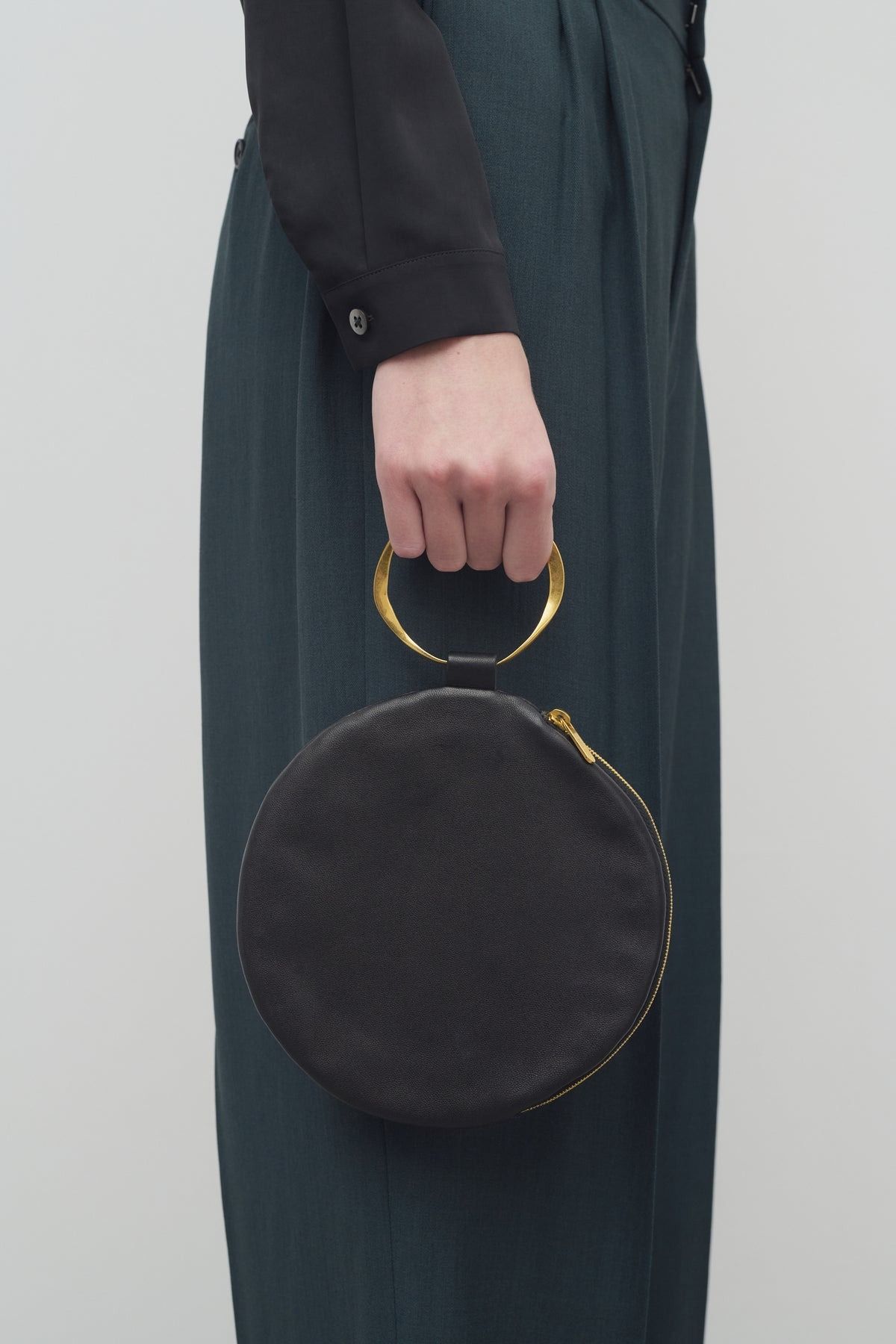The Row Round Bracelet Clutch in Leather worn by Elizabeth Olsen