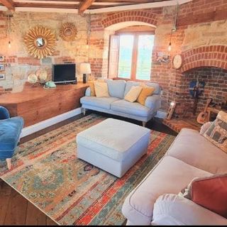 living room with brick with sofa and cushions