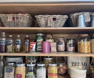 organized larder unit with glass storage jars and baskets