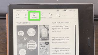 A Kindle Oasis with "Settings" highlighted