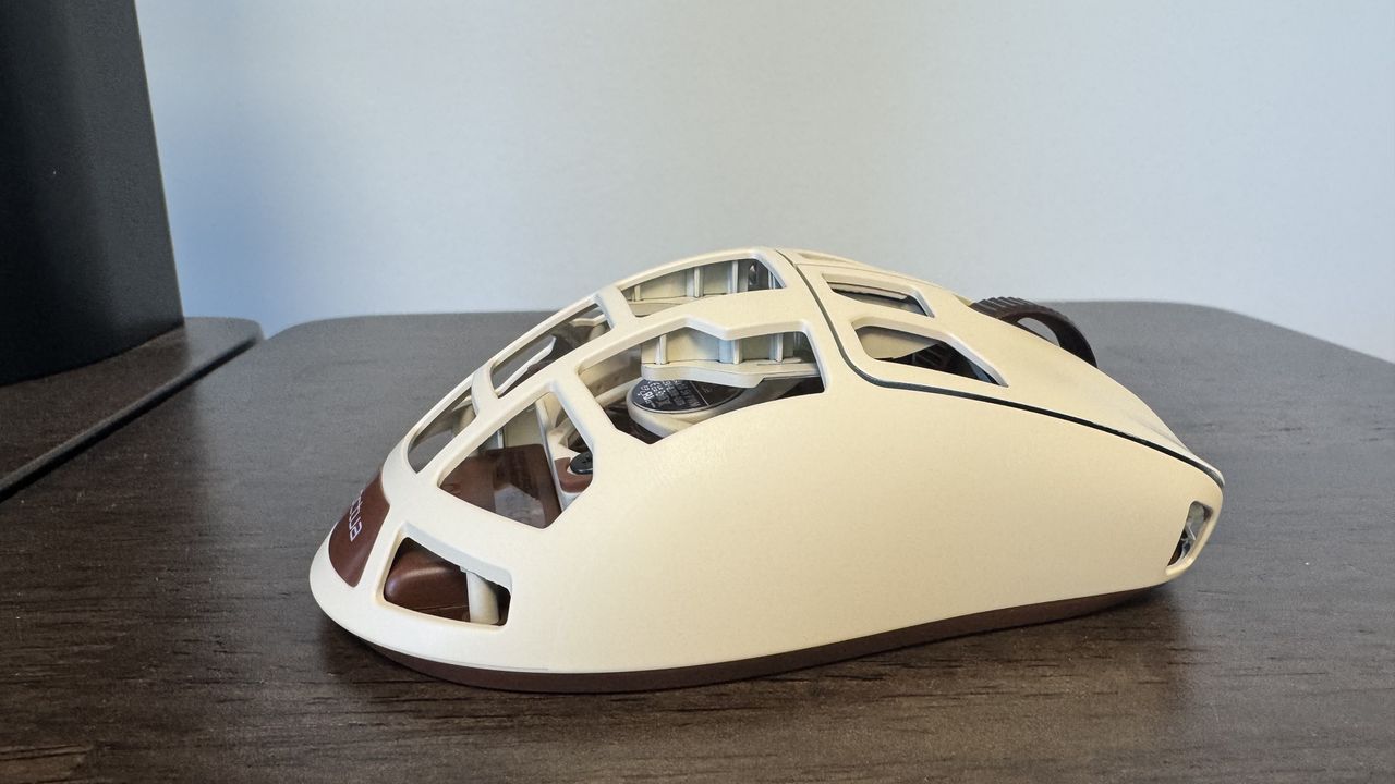 The Pulsar Feinmann F01 Noctua Edition gaming mouse on a wooden desk from the right hand side
