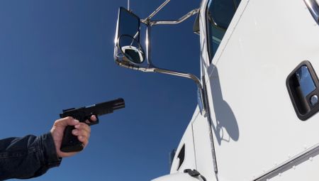 Man robbing a truck with a handgun