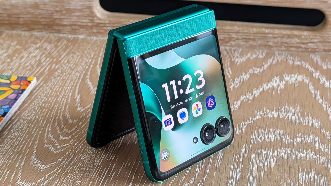 Motorola Razr 2026 in blue, being held in the hand