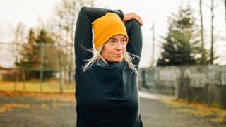 Woman stretching with arms behind her head