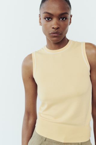butter yellow basic knit top with contrasting piping in white