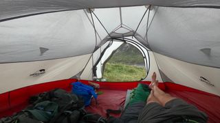 Craig Taylor resting in tent in Eyri National Park