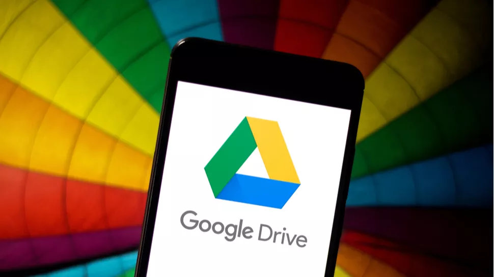 Google Drive on a phone in front of a rainbow-color background