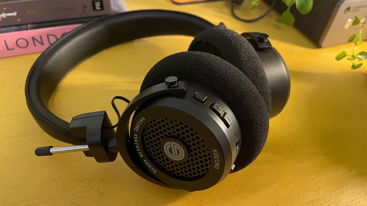 Grado GW100x wired on-ear headphones in black on a yellow wooden surface