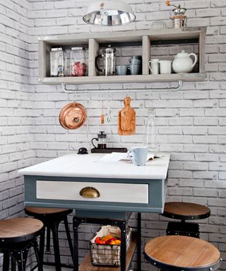 kitchen with white brick wallpaper and white table with chairs and kitchen shelf