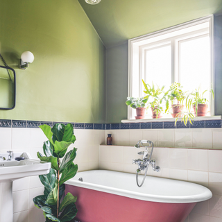 Avcado green bathroom. Green walls, pink bathtub and white tiling