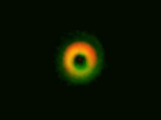 This image by the ALMA radio telescope in Chile shows a giant ring of dust and gas where alien planets may be forming around the star HD142527 about 450 ;light-years from Earth.