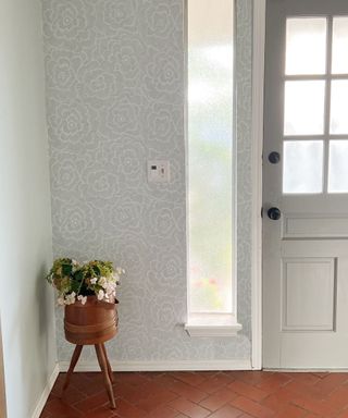 Grey peel and stick wallpaper applied to front of house