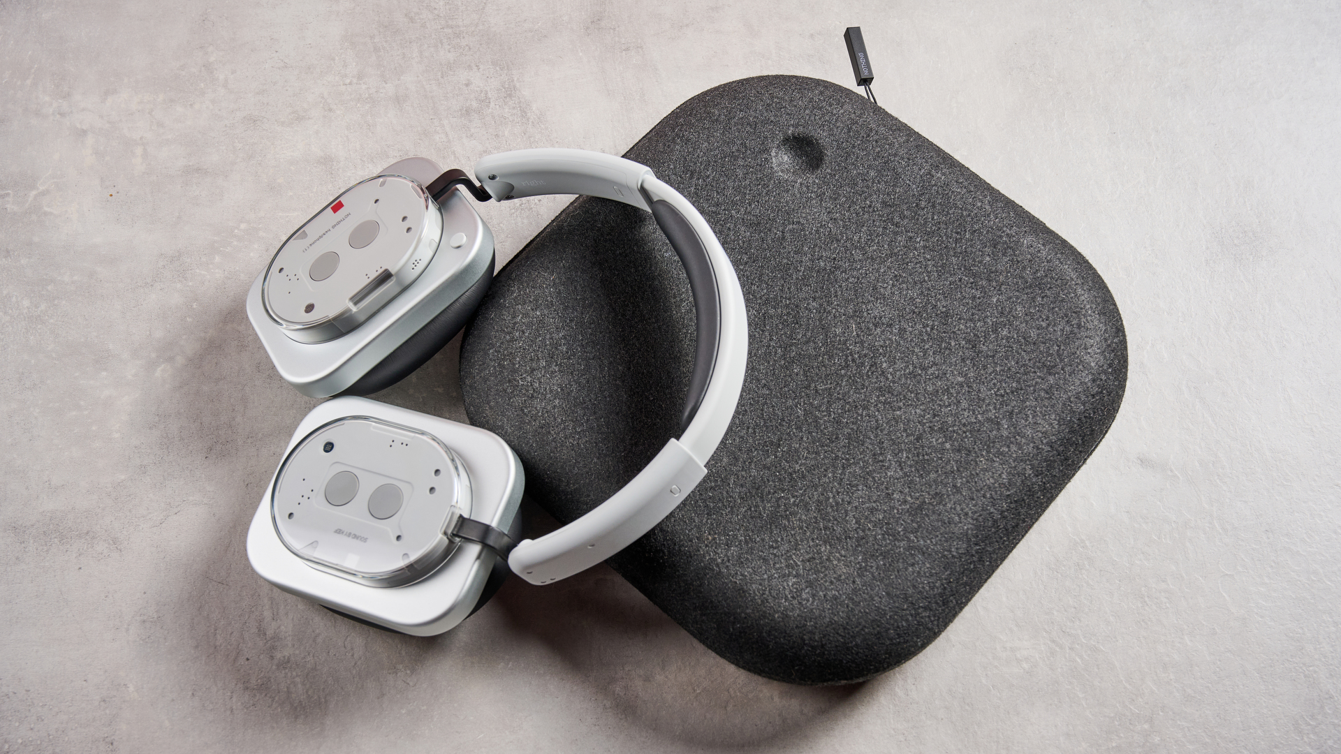 The Nothing Headphone (1) resting on top of their closed felt case
