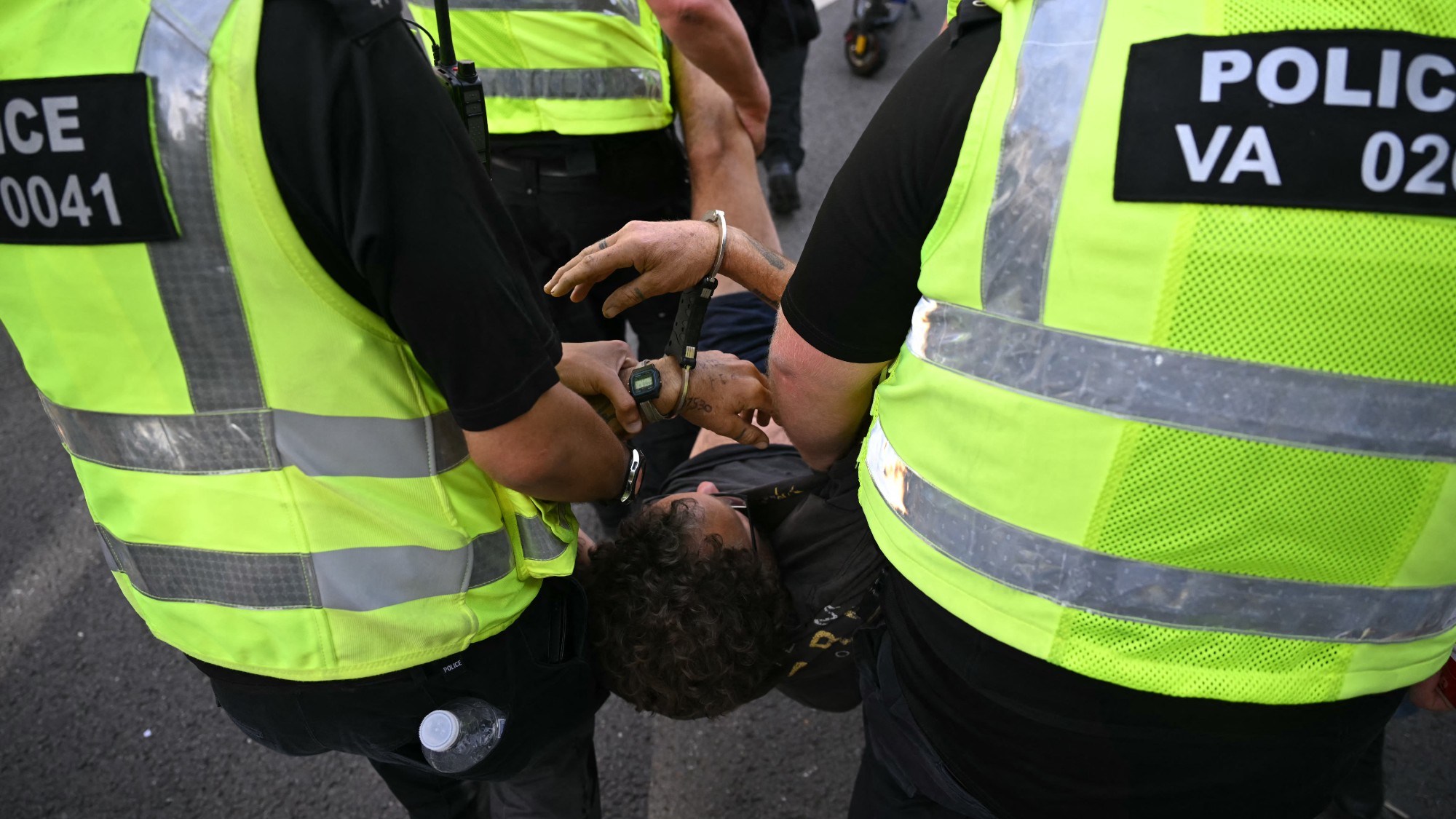 A protester is carried away by police officers at a "Lift The Ban" demonstration in support of the proscribed group Palestine Action