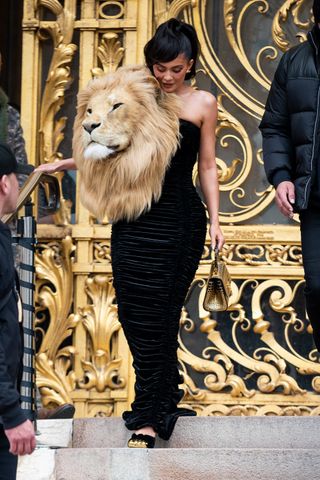 Kylie Jenner leaving Schiaparelli's couture show wearing a dress with a faux lion head