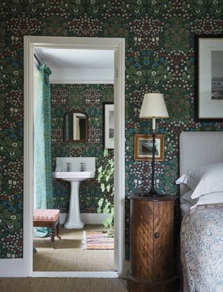 Morris & Co wallpaper and fabrics in bedroom and ensuite bathroom