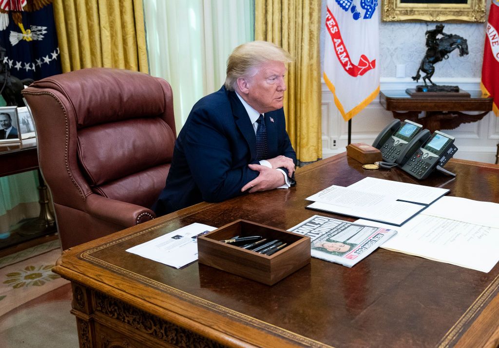 Trump sits in the Oval Office