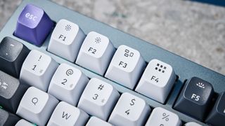 A photo of the Keychron Q1 Pro in gray aluminum with white, black and purple keycaps.