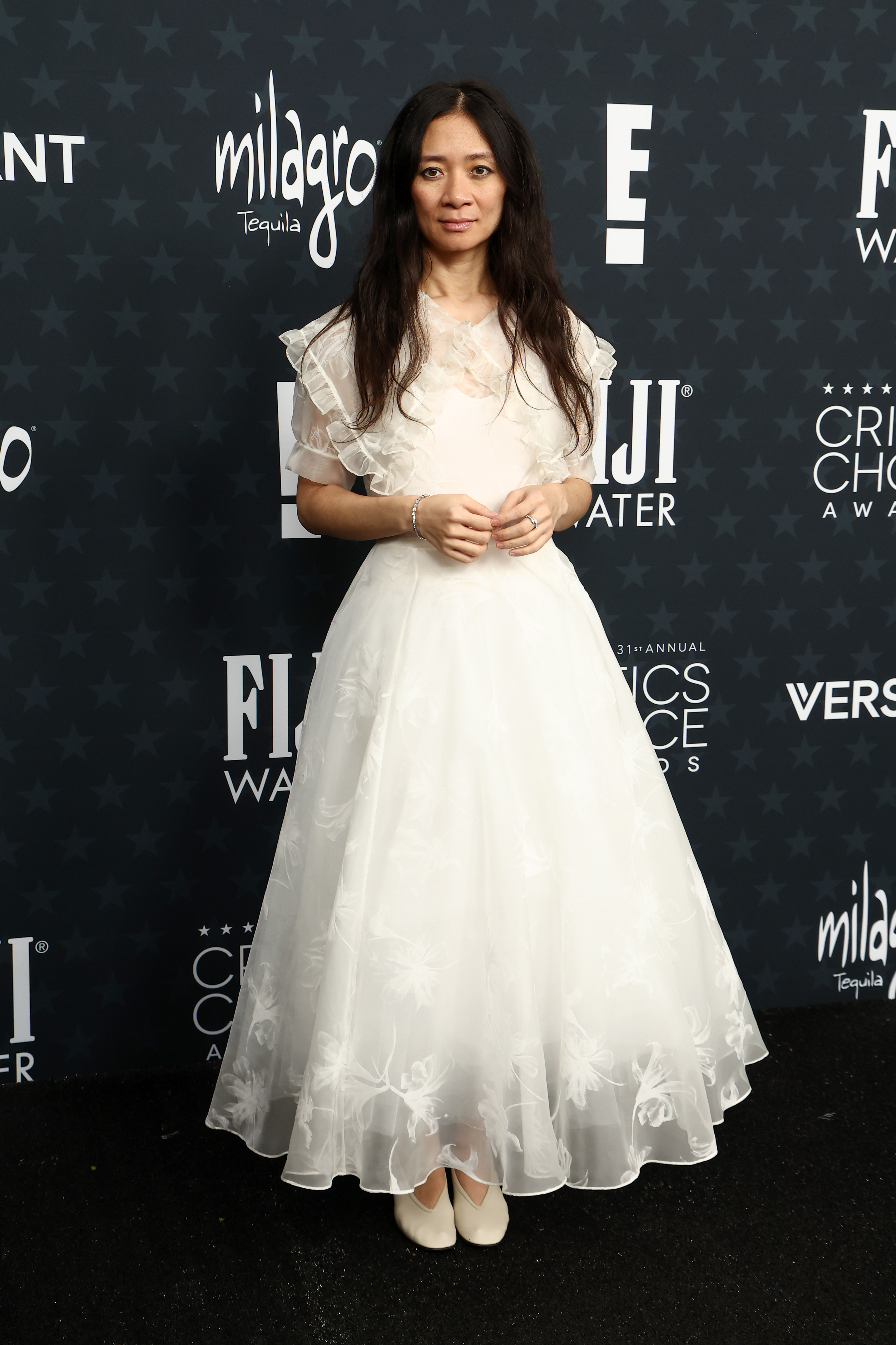 Chloe Zhao wearing a white dress at the 2026 critics choice awards