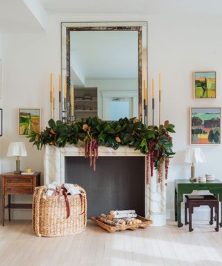 traditional living room with a marble mantel fireplace decorated with christmas with a large foliage garland