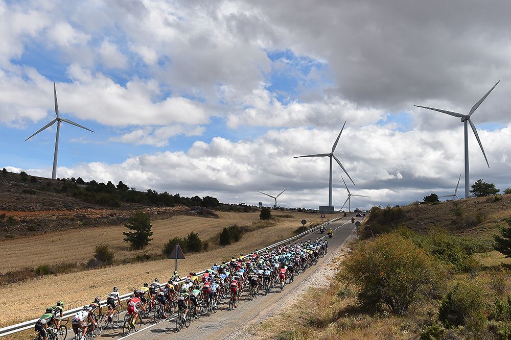 The peloton passes several wind turbines during stage 18.