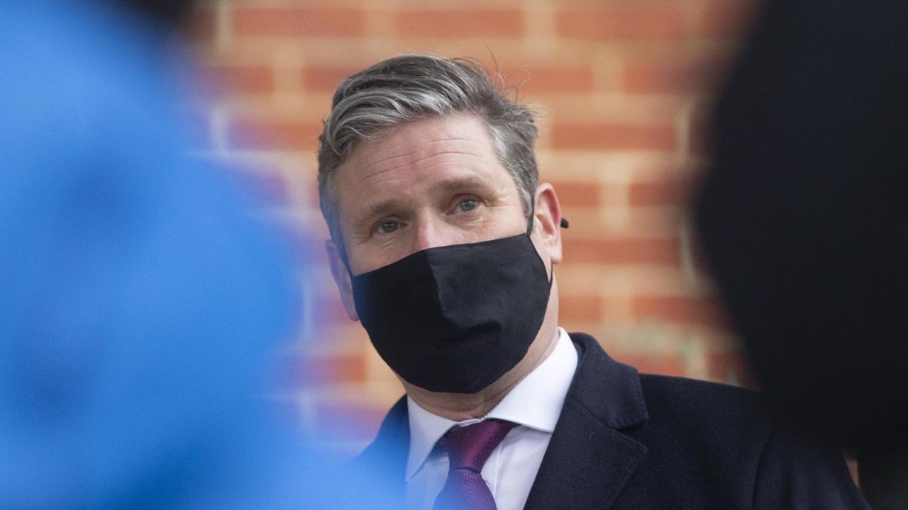 Keir Starmer visits a building wrapped in unsafe cladding.