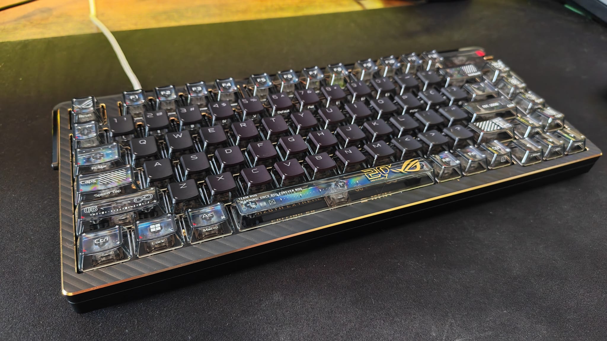 An Asus ROG Azoth Extreme 20 keyboard under yellow lighting