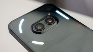 The camera island on the back of the Nothing Phone (2a) with the glyph lights illuminated