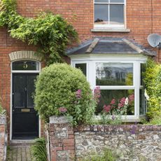 front of facebrick house showing front door and bay window