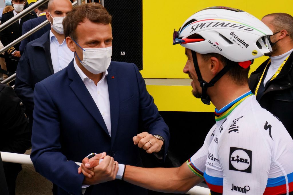 French President Emmanuel Macron shakes hands with Team Deceuninck Quicksteps Julian Alaphilippe of France after the 18th stage of the 108th edition of the Tour de France cycling race 129 km between Pau and Luz Ardiden on July 15 2021 Photo by Thomas SAMSON AFP Photo by THOMAS SAMSONAFP via Getty Images