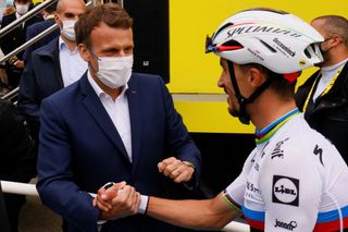 French President Emmanuel Macron shakes hands with Team Deceuninck Quicksteps Julian Alaphilippe of France after the 18th stage of the 108th edition of the Tour de France cycling race 129 km between Pau and Luz Ardiden on July 15 2021 Photo by Thomas SAMSON AFP Photo by THOMAS SAMSONAFP via Getty Images
