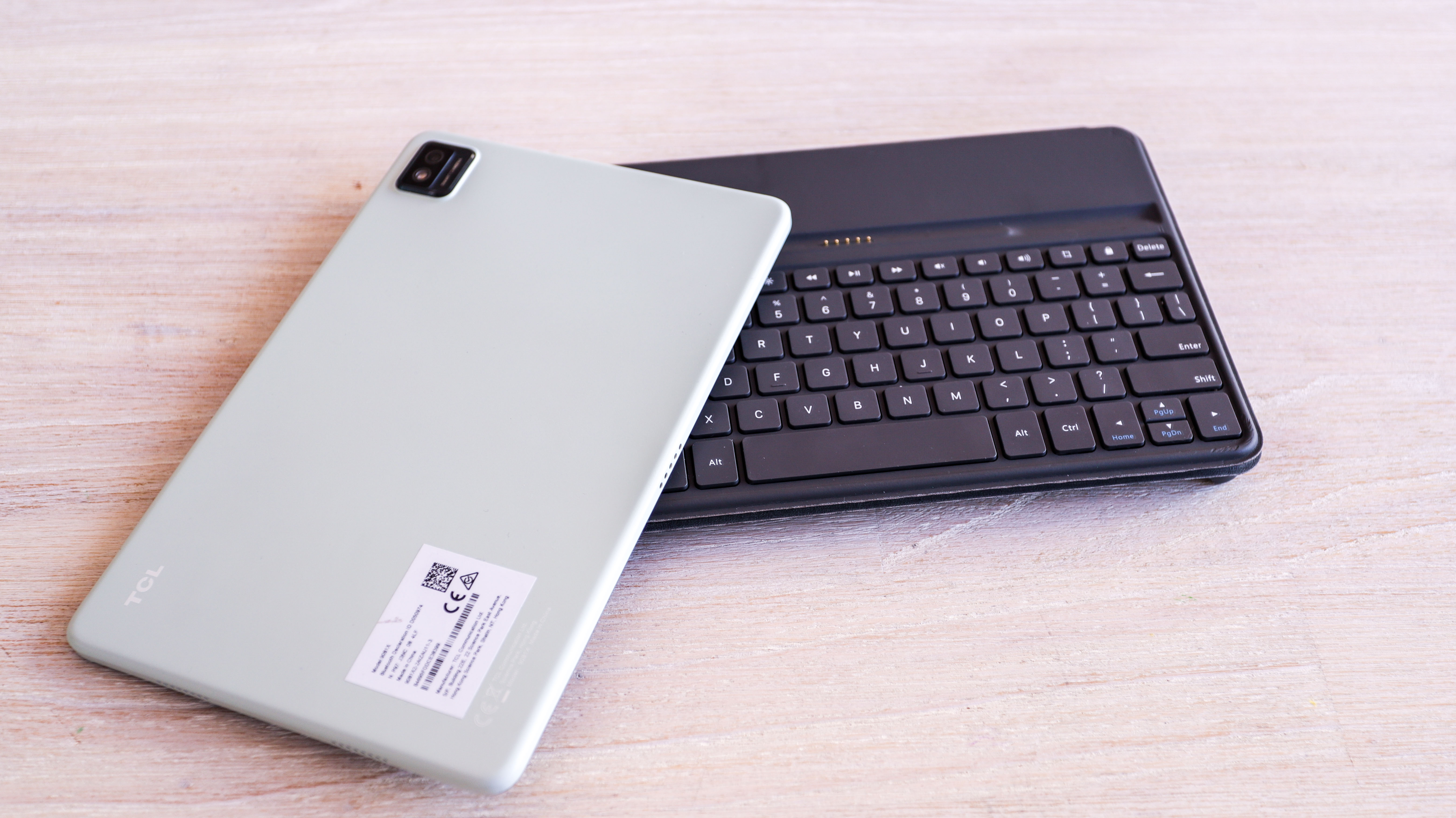 The green back of the TCL Nxtpaper 10s, with the tablet lying on its keyboard.