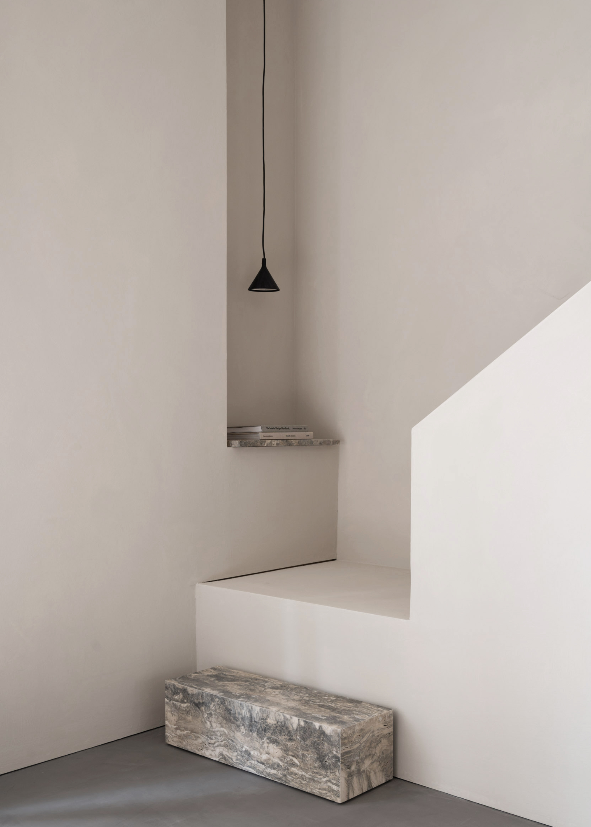 A crisp, clean white room with a single stone step