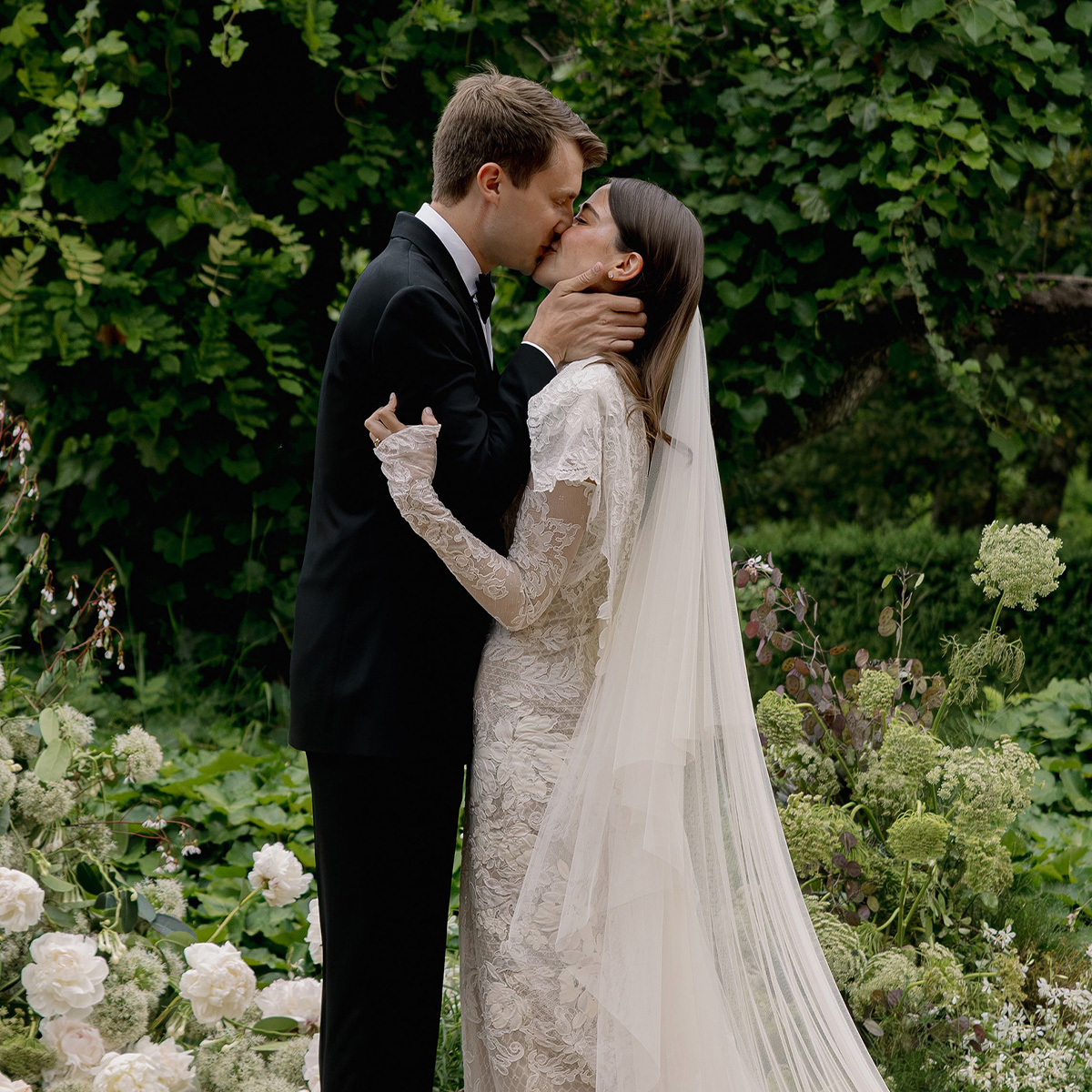 An image of abbie and max kissing at their wedding.